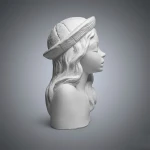 Popiersie gipsowe kobiece V marki Artesania. Portret kobiety w kapeluszu z kwiatami  - profil prawy. Wymiary: wys. 10x szer. 6 cm x głęb. 5,5 cm